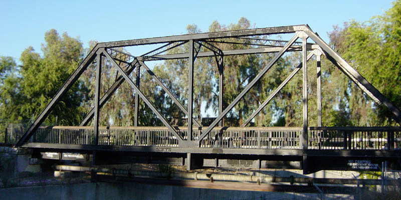 A truss bridge with diagonal beams forming triangles whose areas can be calculated from side lengths.