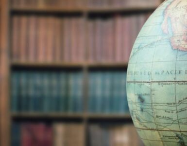 A globe displayed in a library, suggesting world geography and global time zones.