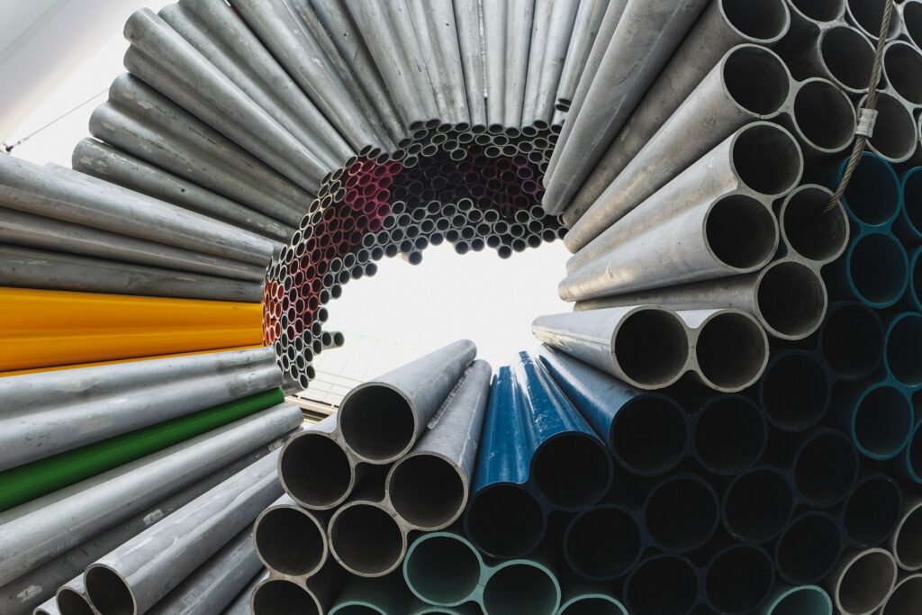 Rolled metal sheets showing the smooth surfaces and bendable form associated with metallic bonding