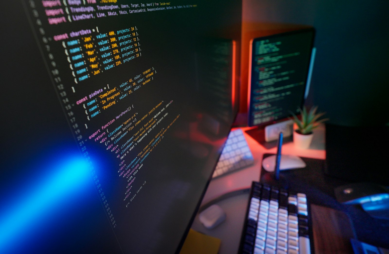 Programming code displayed on computer screens during front-end web development