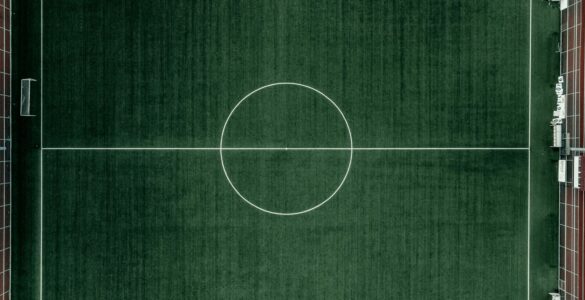 An aerial view of a soccer field showing goal lines and player positions