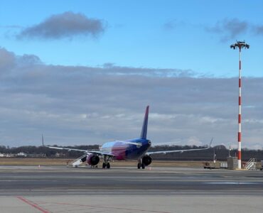 A commercial airplane on a runway preparing for takeoff on a clear day
