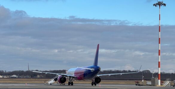 A commercial airplane on a runway preparing for takeoff on a clear day