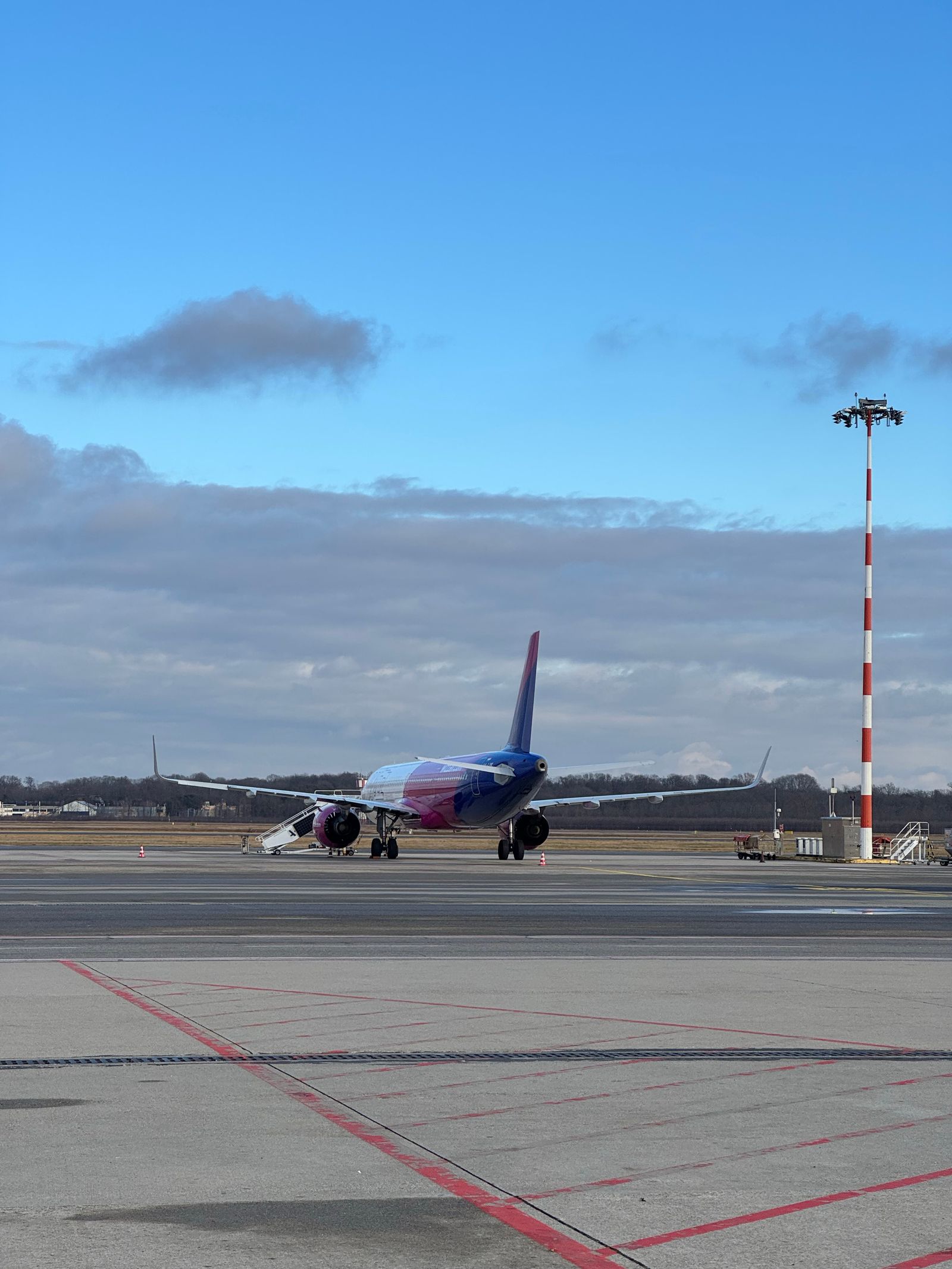 Commercial airplane on a runway before takeoff, where aircraft spacing helps manage wake turbulence.