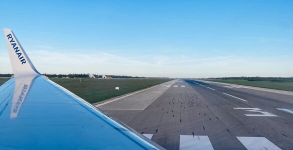 View from an airplane window toward a runway, where low-altitude wind shear can matter during takeoff and landing.