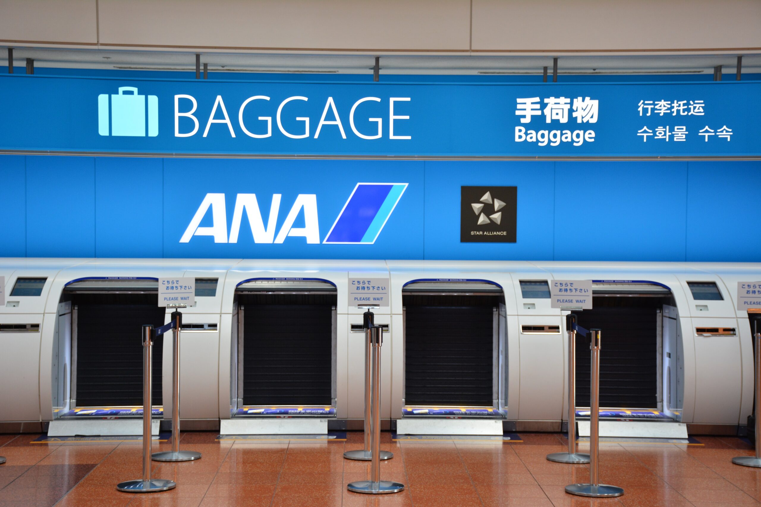 Luggage moving through an airport screening area