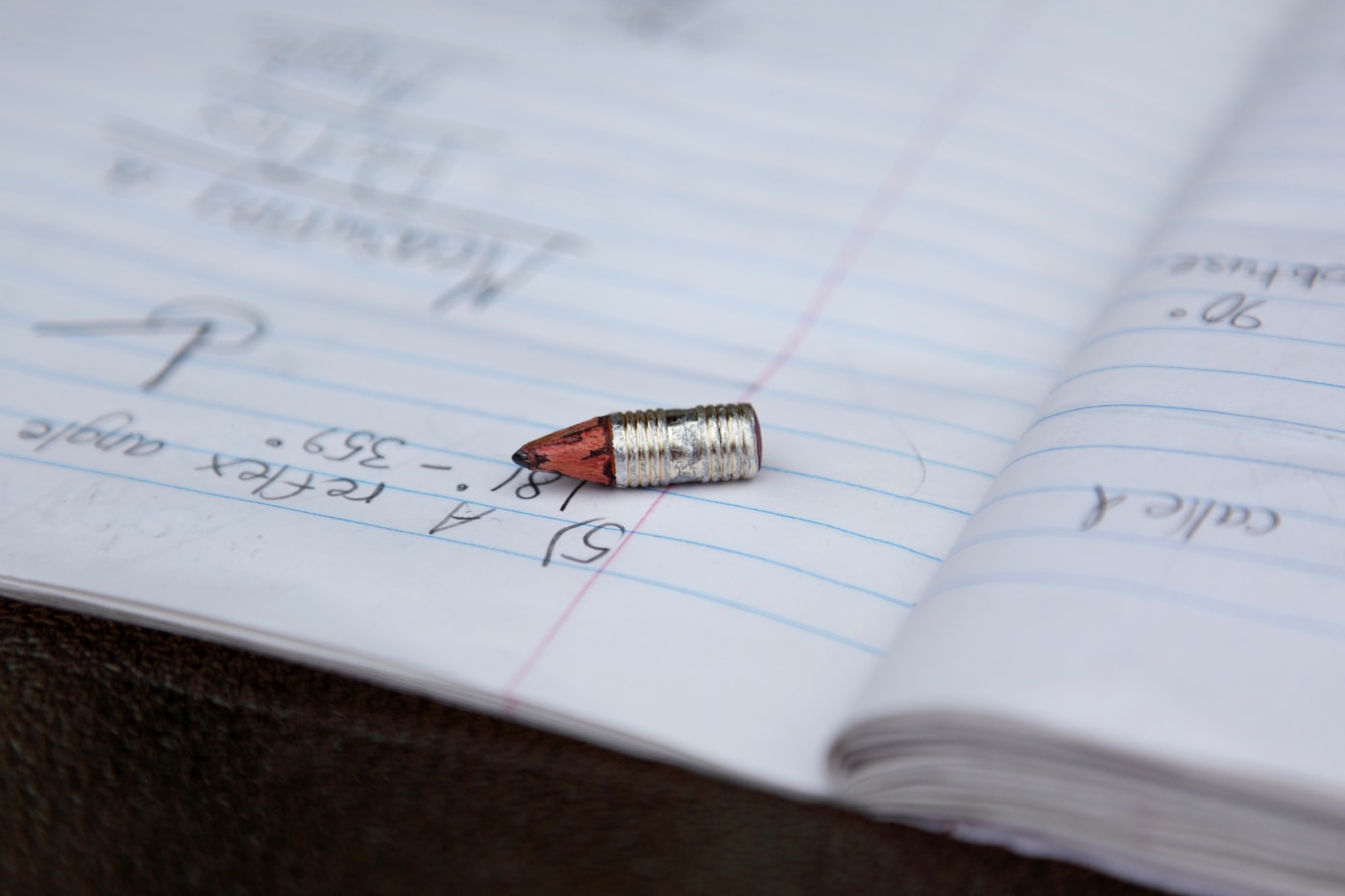 A pencil on an open notebook page for math practice