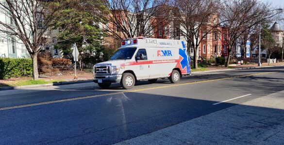 An ambulance on a city street, used to explain why sirens change pitch as they pass.