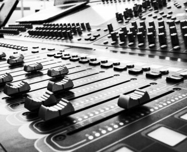 Close view of soundboard faders used for audio mixing