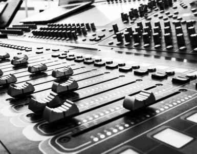 Close view of soundboard faders used for audio mixing