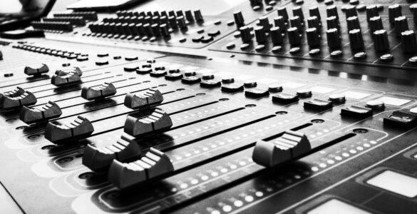 Close view of soundboard faders used for audio mixing