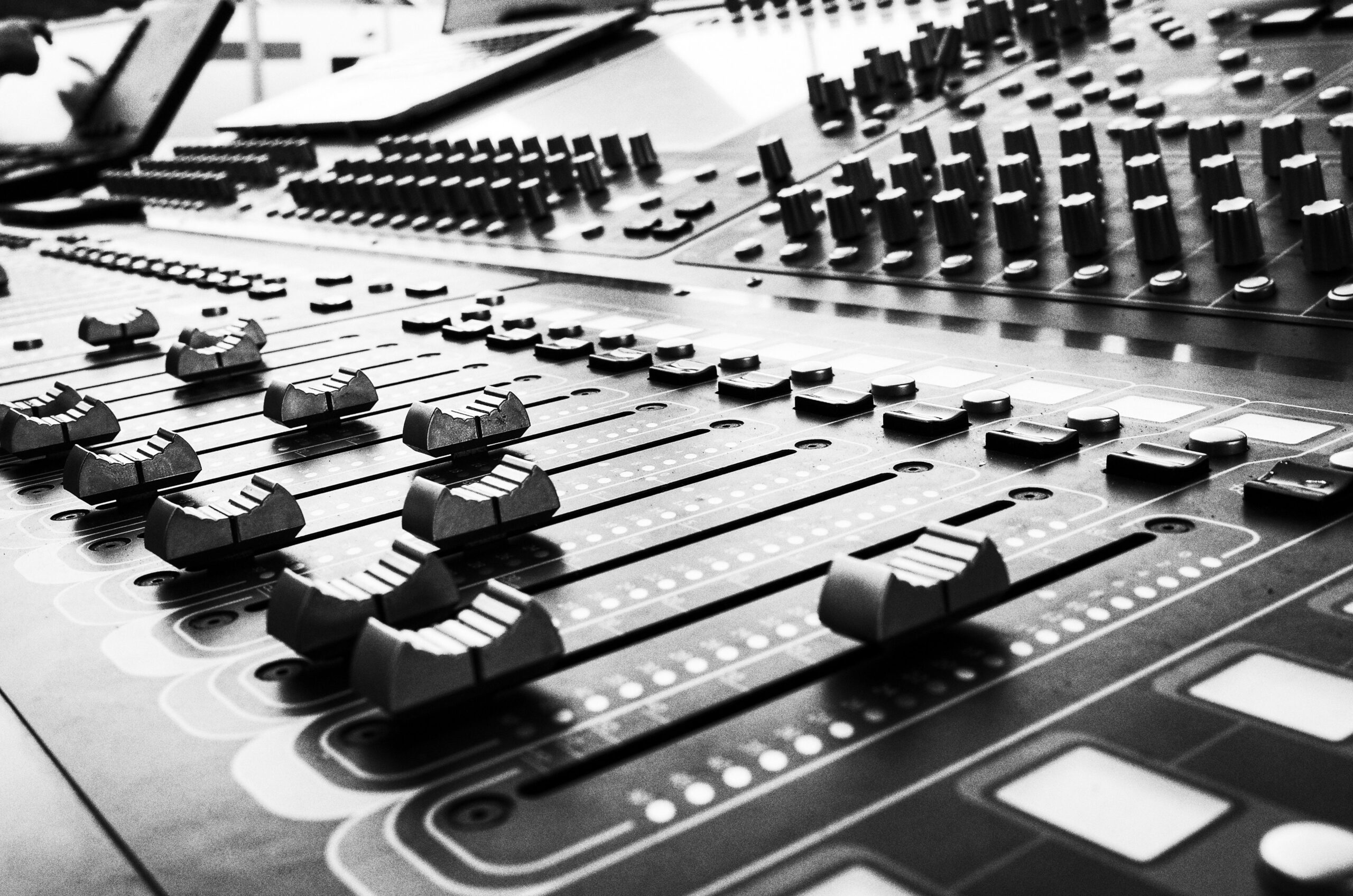 Close view of soundboard faders used for audio mixing