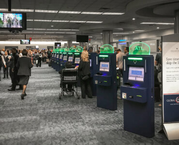 Automated passport control kiosks inside a busy airport terminal