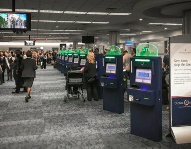 Automated passport control kiosks inside a busy airport terminal