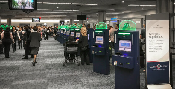 Automated passport control kiosks inside a busy airport terminal