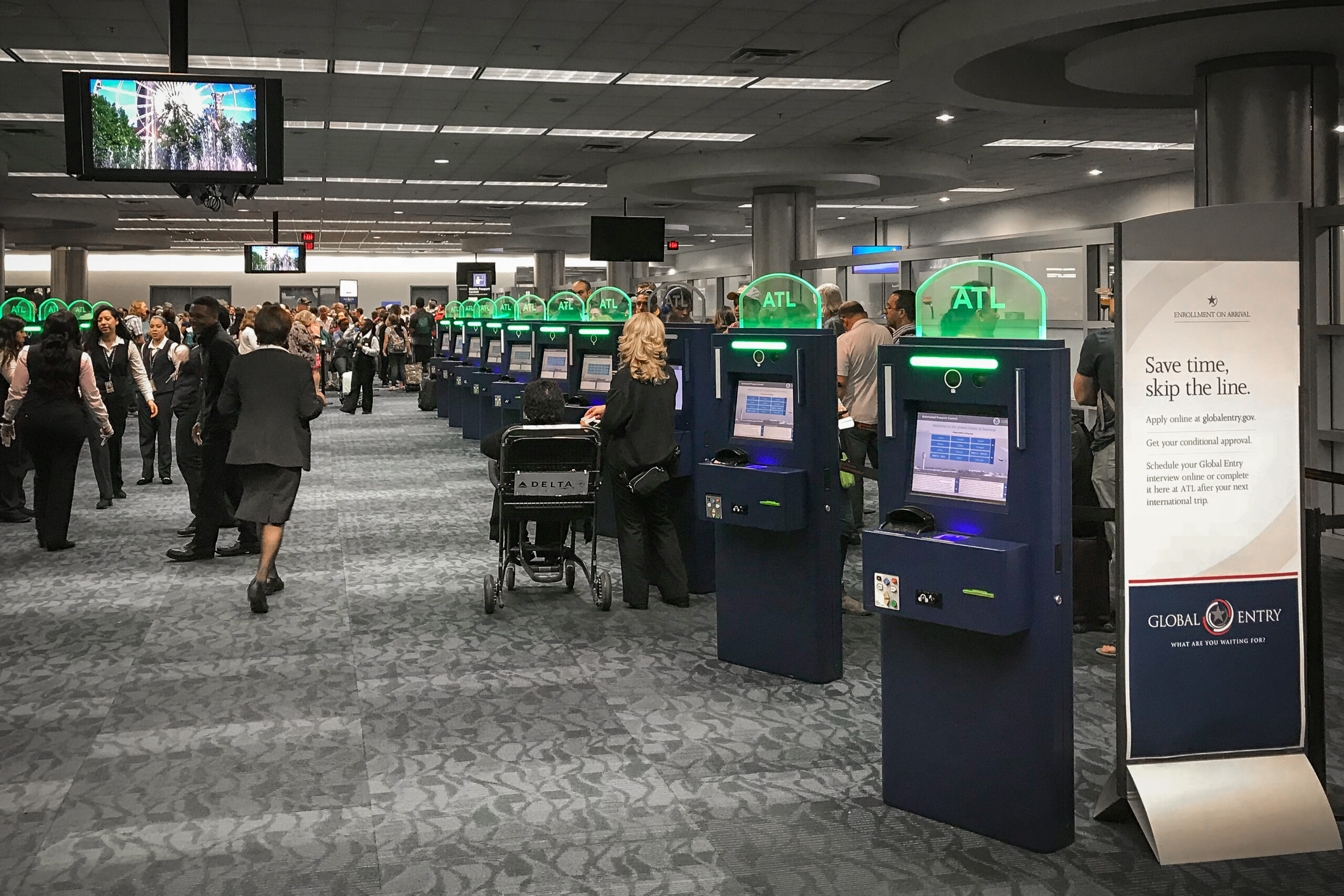 Automated passport control kiosks inside a busy airport terminal