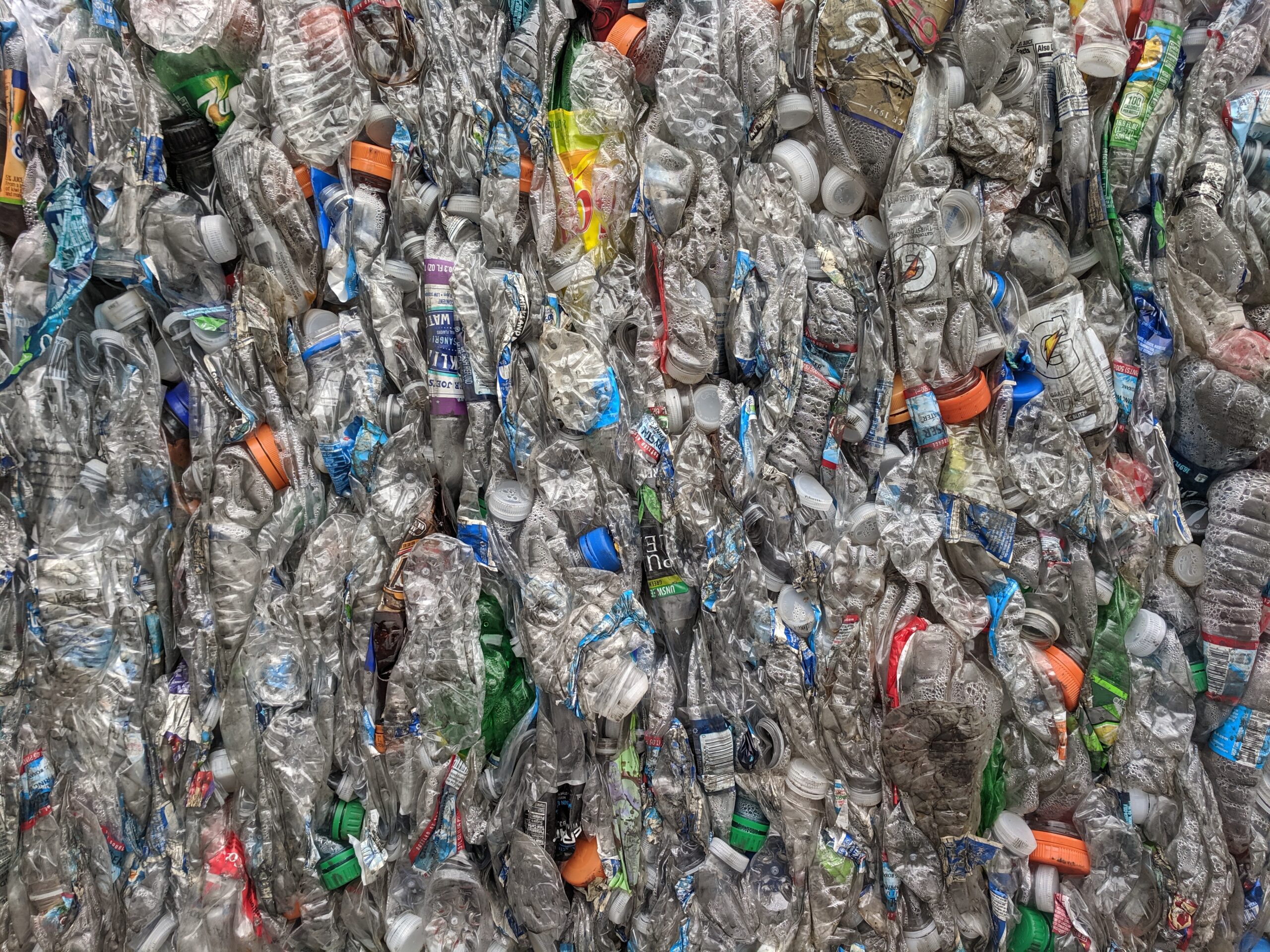 Crushed PET plastic bottles bundled into bales at a recycling facility
