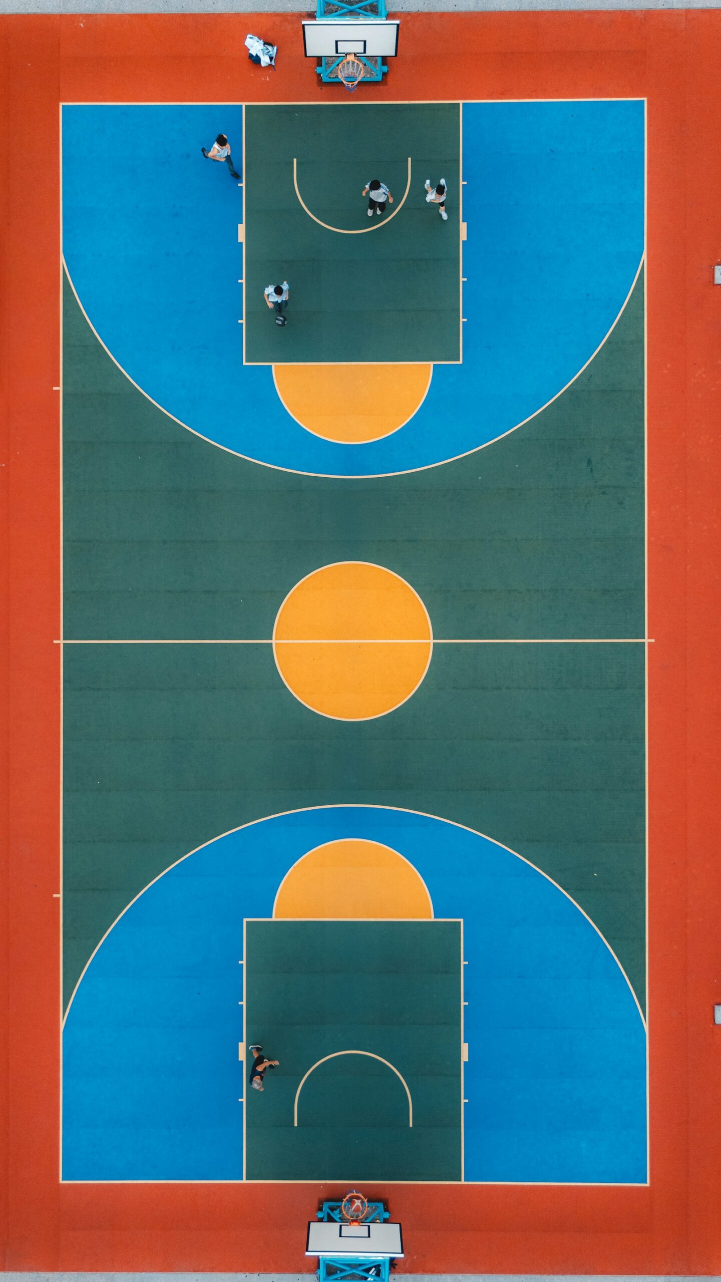 Basketball players spread across a court during a game