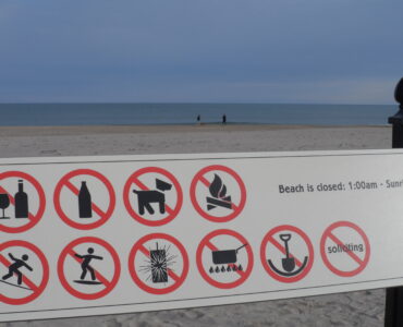 Beach warning signs posted near the shore