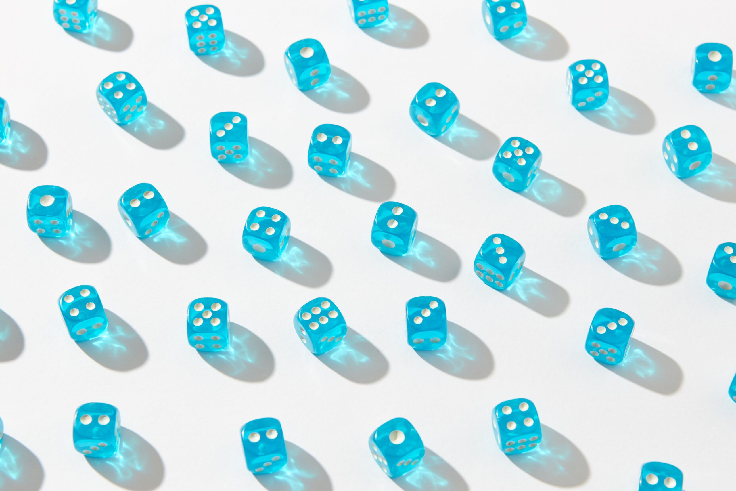 Blue dice arranged on a white surface to show repeated random outcomes.