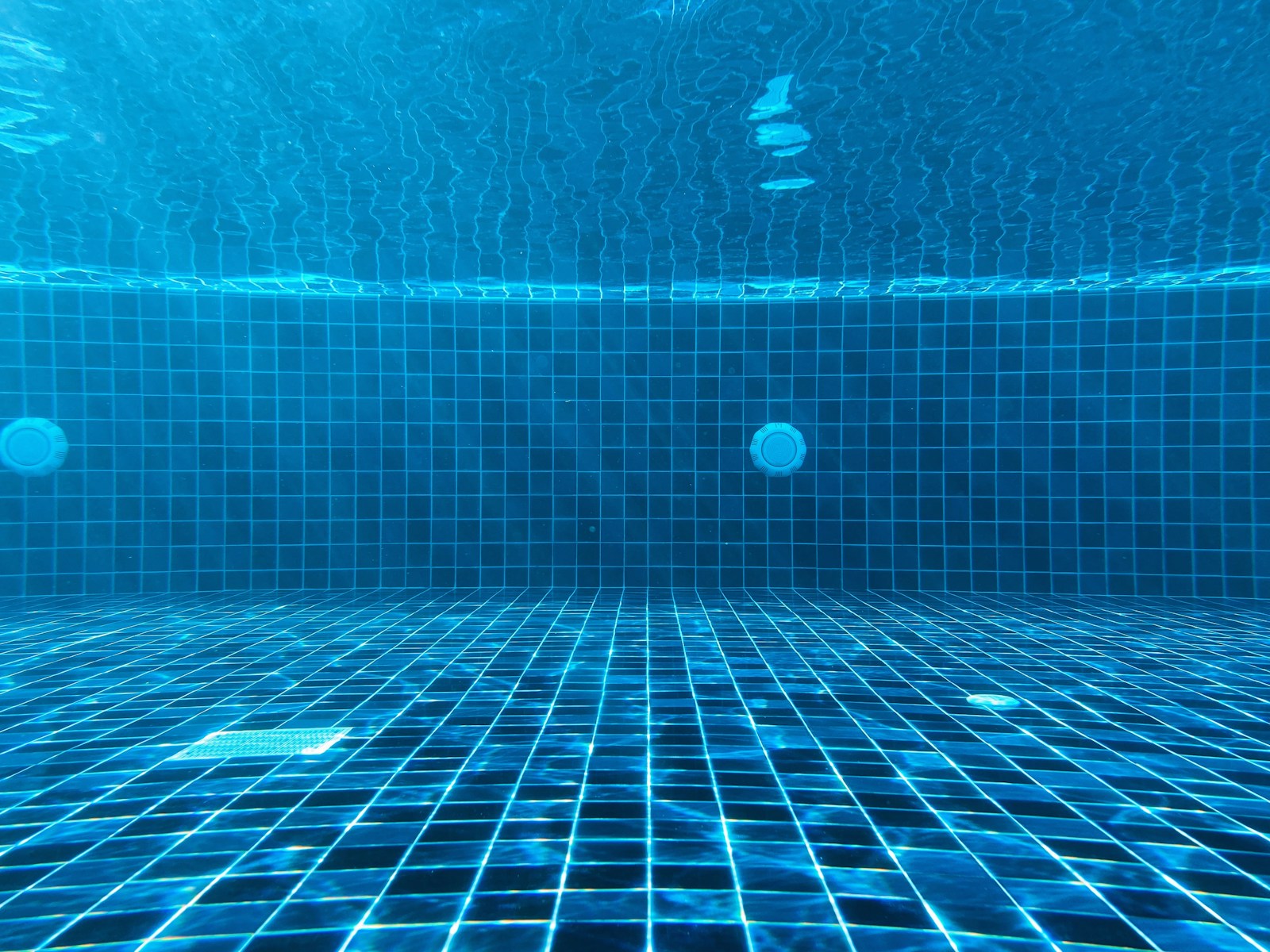 Blue swimming pool water with ripples