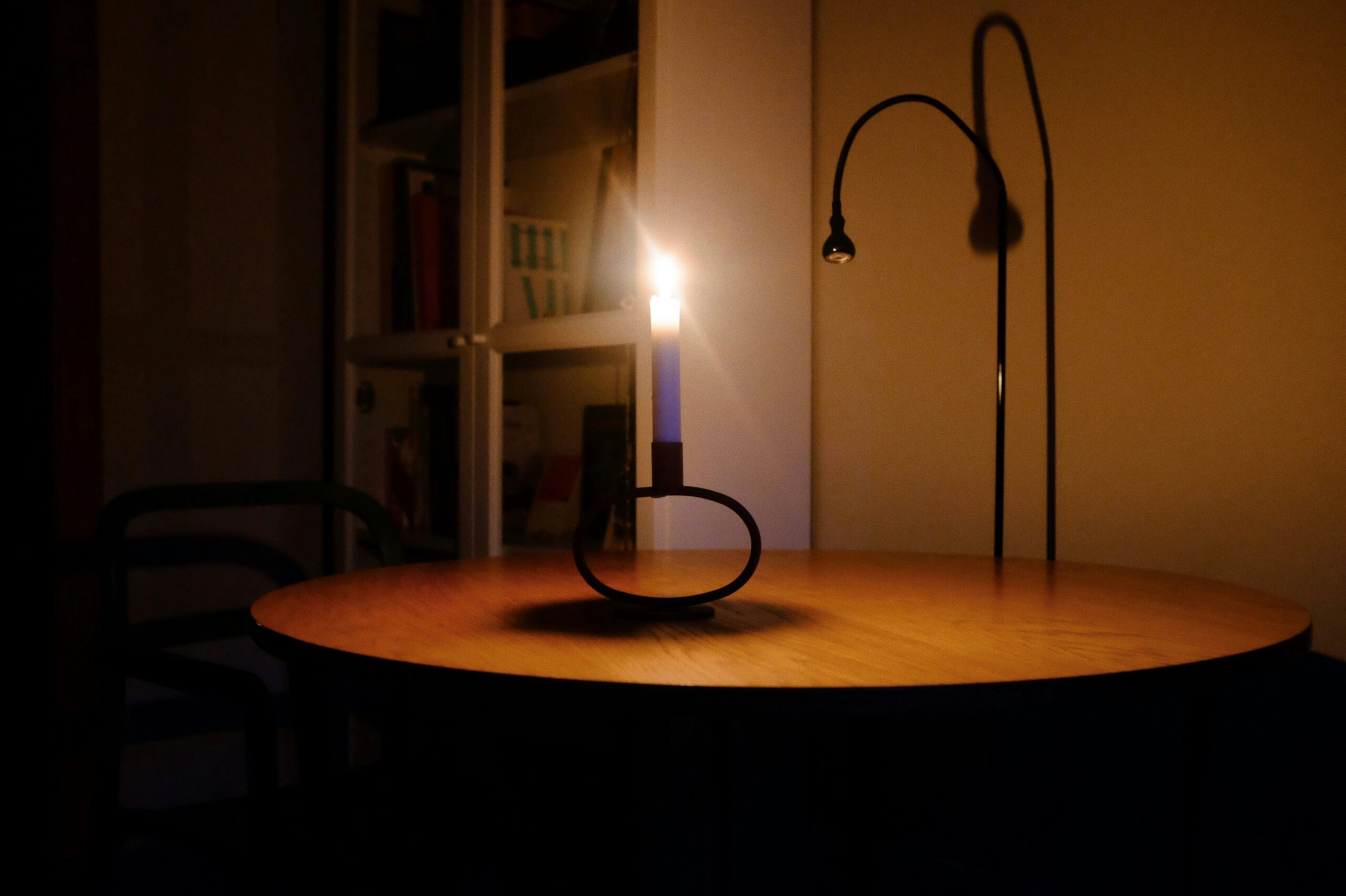 A candle lighting a table during a dark power outage