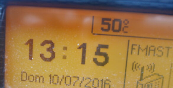 A car temperature display showing hot weather conditions inside a vehicle