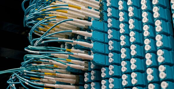 Blue fiber optic cables connected to a data center patch panel