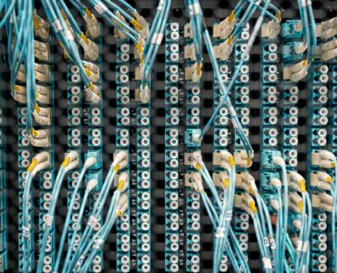 Fiber optic cables connected to a network panel in a data center