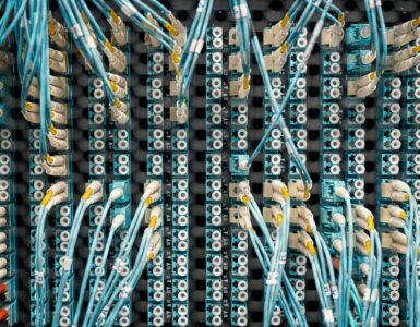 Fiber optic cables connected to a network panel in a data center