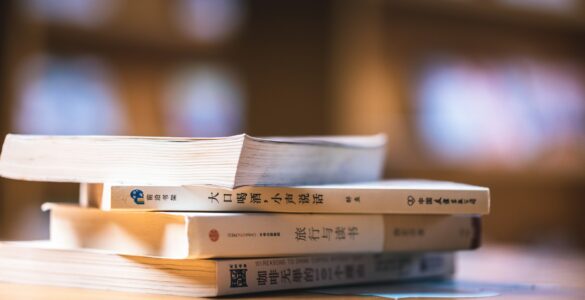 Chinese language books on a study table for learning Mandarin grammar and question particles.