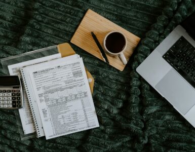 A laptop and paperwork used to review college FERPA record access and student privacy forms