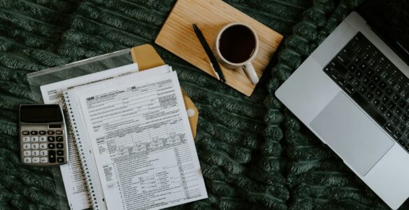 A laptop and paperwork used to review college FERPA record access and student privacy forms