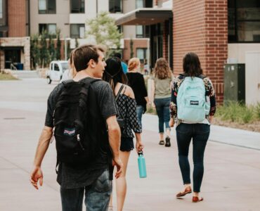 New college students walking across campus during summer orientation