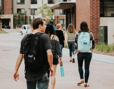 New college students walking across campus during summer orientation