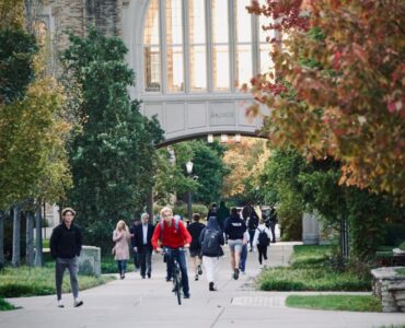 College students walking across campus before move-in and roommate planning