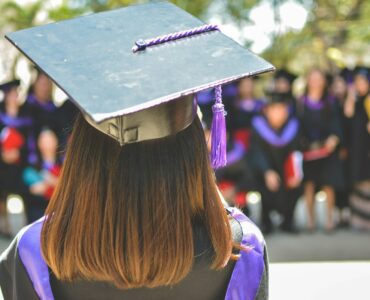 College students walking on campus while families plan how to use education savings