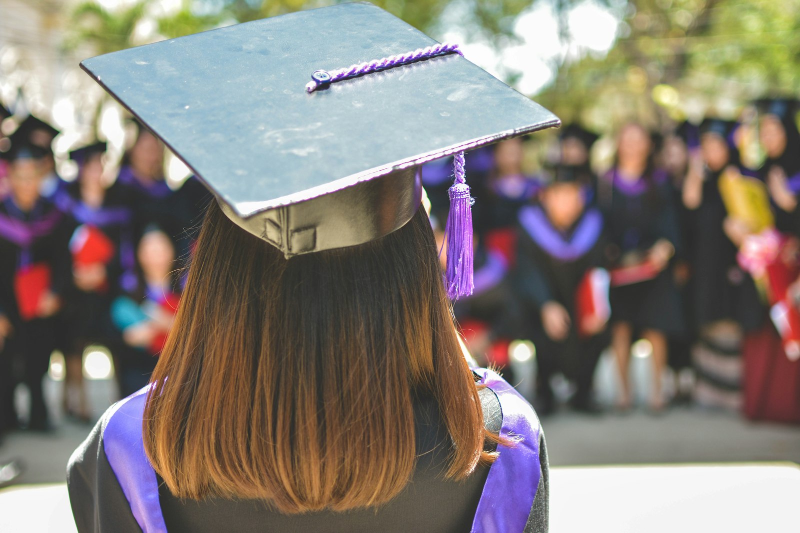 College students walking on campus while families plan how to use education savings