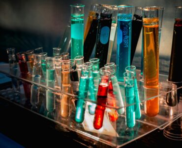 Colorful liquids in test tubes arranged on a chemistry lab bench