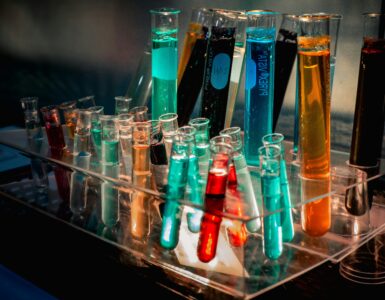 Colorful liquids in test tubes arranged on a chemistry lab bench