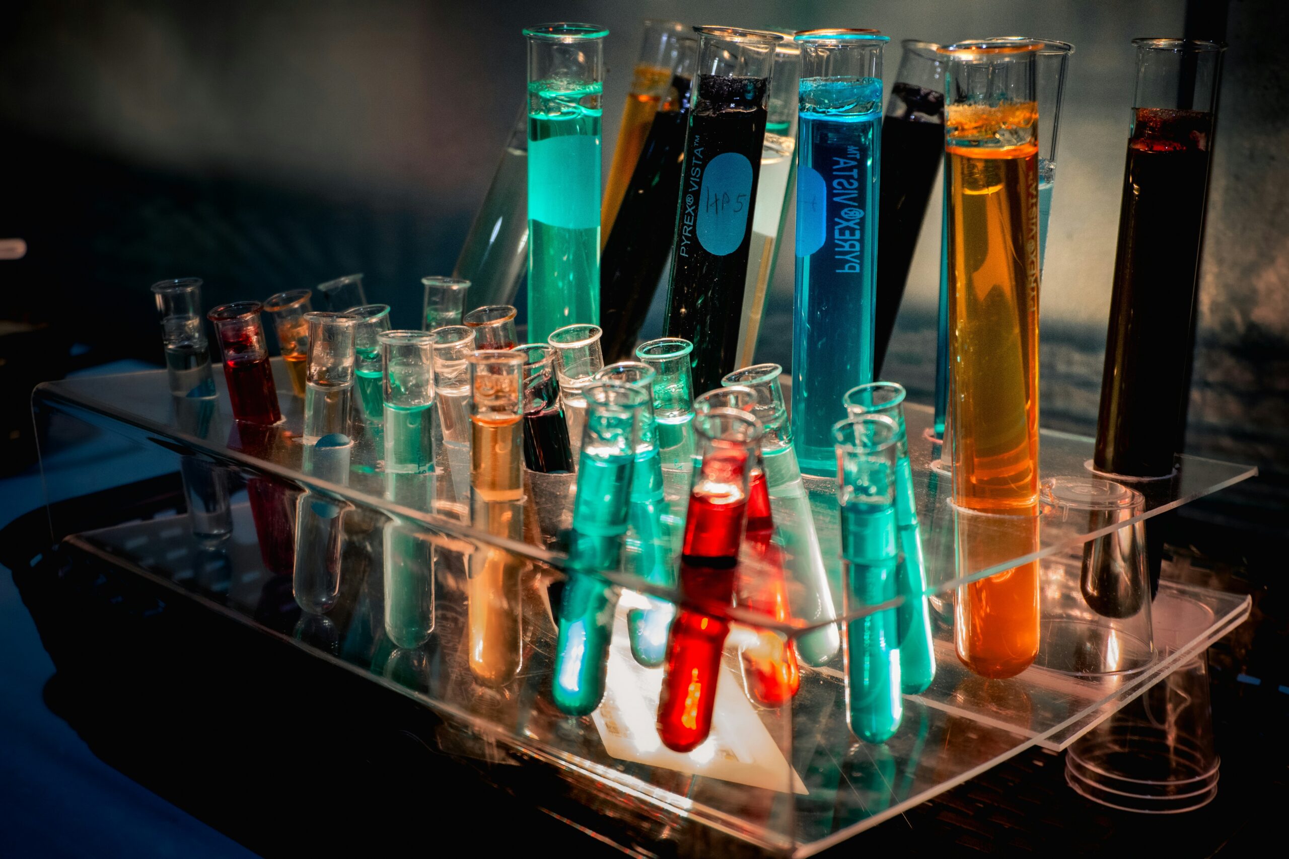 Colorful liquids in test tubes arranged on a chemistry lab bench