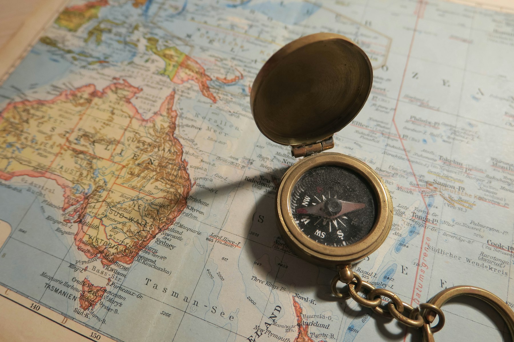 A compass resting on a map to show direction and navigation