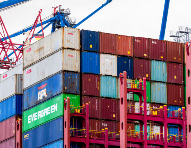 A container ship loaded with cargo at a port terminal