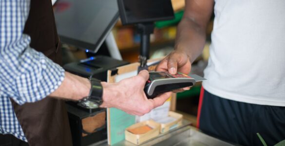 A payment card at a checkout terminal, where check digits help catch mistyped number entries.