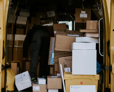 Cardboard packages stacked inside a delivery van for online orders crossing shipping networks
