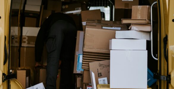 Cardboard packages stacked inside a delivery van for online orders crossing shipping networks
