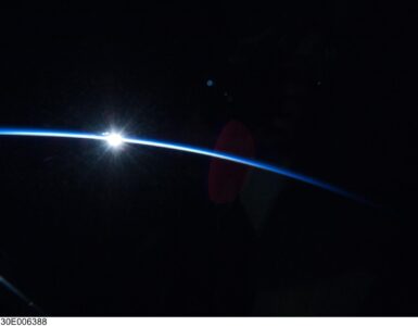 Sunrise over Earth's curved horizon photographed from orbit