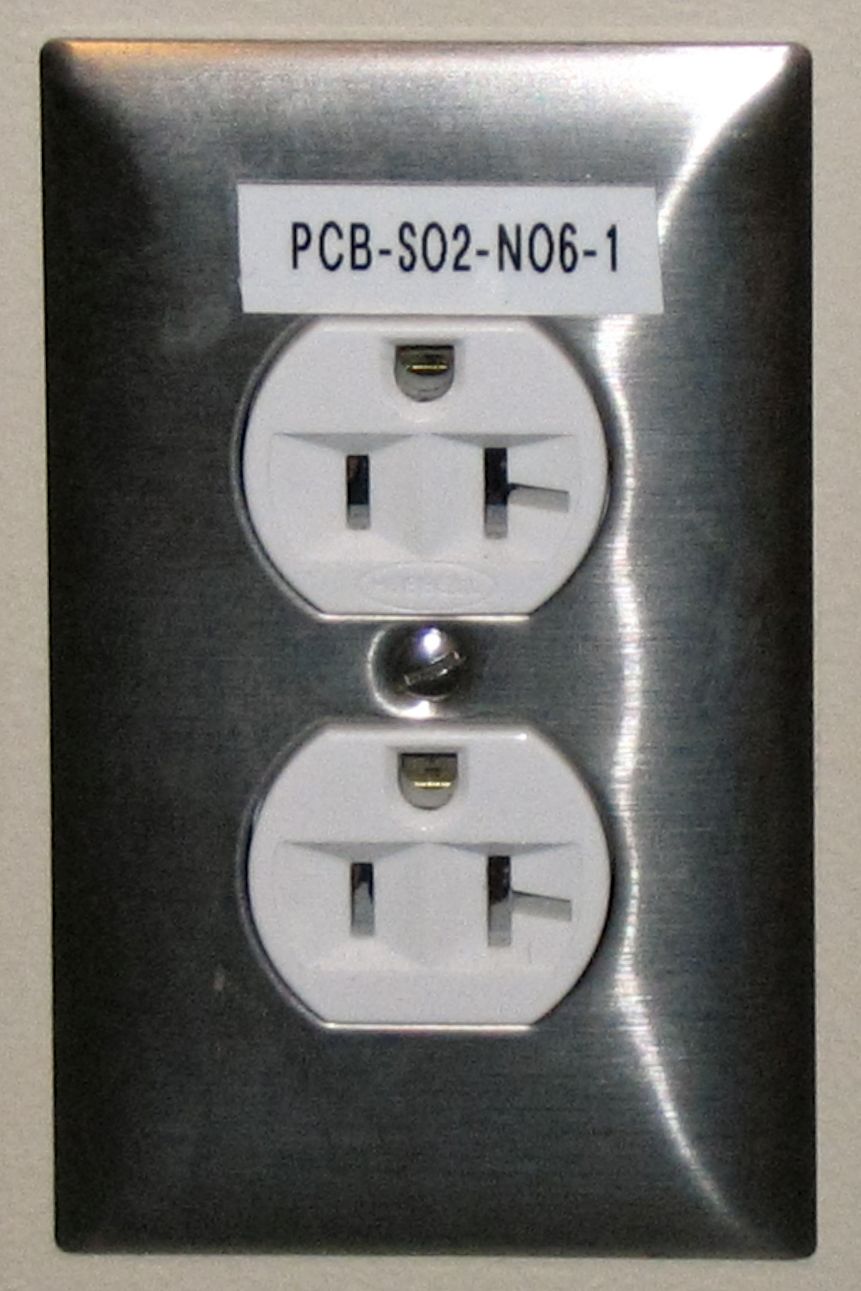 A grounded electrical outlet labeled with hot, neutral, and ground connections