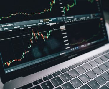 A laptop screen shows financial charts used to follow changing interest rate expectations.