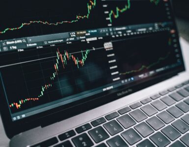 A laptop screen shows financial charts used to follow changing interest rate expectations.